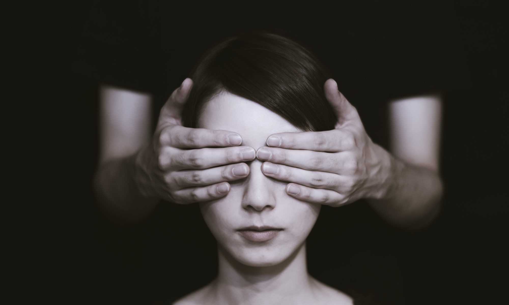 Woman with hands over her eyes