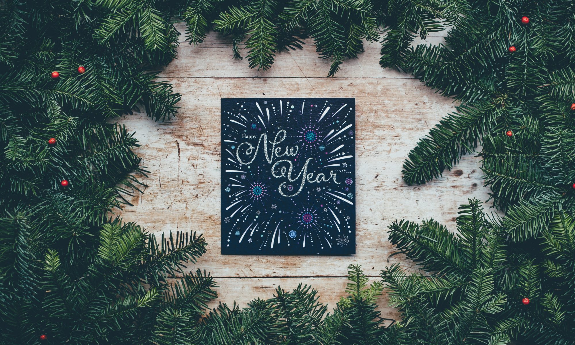 Happy new year sign surrounded by greenery